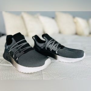 Adidas tennis shoes in ombré from white to deep charcoal to pitch black.